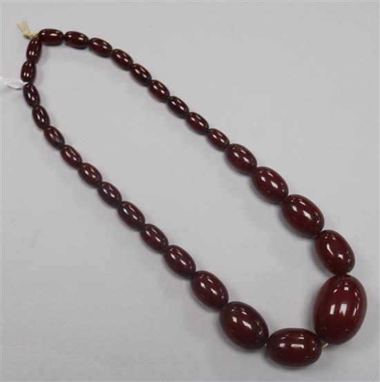 A single strand graduated simulated cherry amber bead necklace, gross 53g, 42cm.